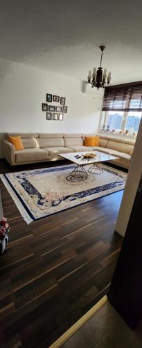 a living room with a couch and a table at Ana Apartament in Ferizaj