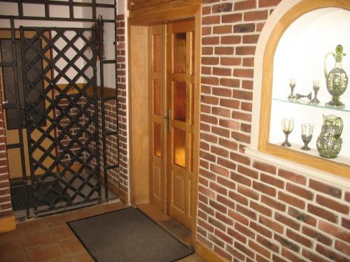 a brick walled room with a door and a window at penzion - restaurace Na Výšince in Turnov
