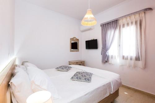 Ένα ή περισσότερα κρεβάτια σε δωμάτιο στο Kampos Villa Iii