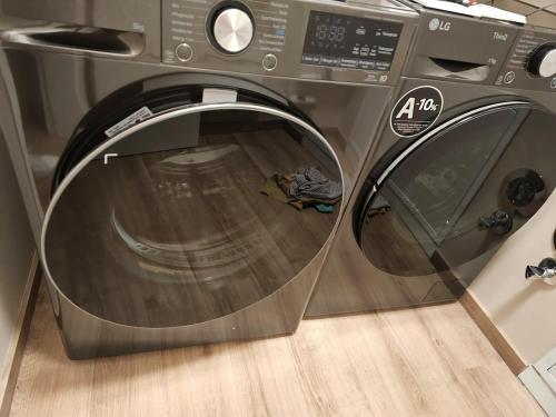 a close up of a washing machine with its door open at Abbey View Suites in Echternacherbrück