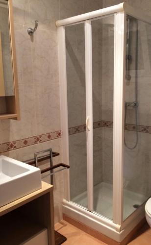 a shower with a glass door in a bathroom at Sitges Beach Panorama in Sitges
