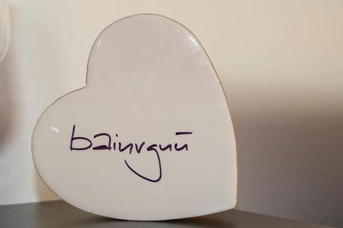 a white heart shaped alarm clock sitting on a table at Yvonne Mayer in Scuol