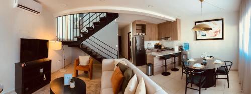 a kitchen and a living room with a staircase at Casa de la Paz in Colima