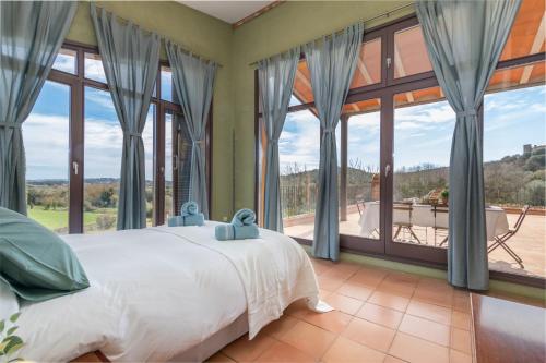 um quarto com uma cama e janelas grandes em Mas Darovie em Foixá