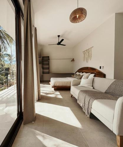 a living room with a couch and a bed at Casa Caona in El Valle