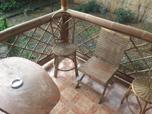 a patio with a table and a chair and a table at Pagdayon Traveler's Inn in Puerto Princesa City