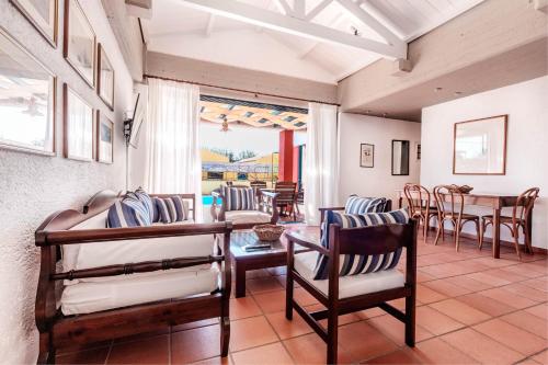a living room with chairs and a table at Barbati Beach - Villa Lefkada in Barbati