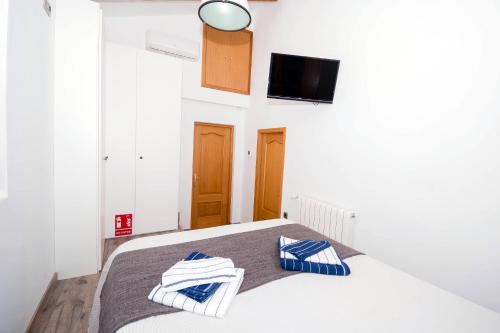 Una cama o camas en una habitación de En el corazón de Sagunto