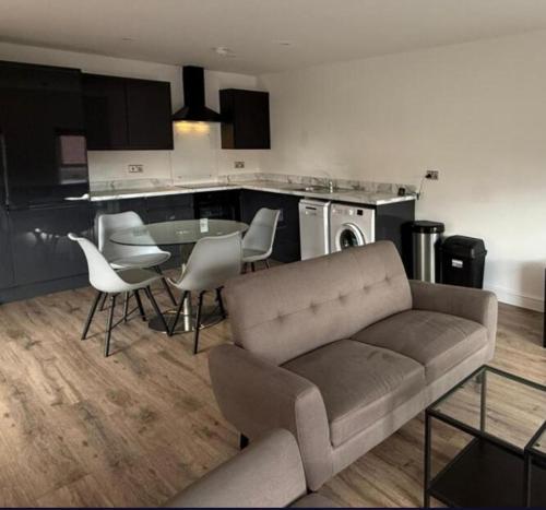a living room with a couch and a table and chairs at Sarah's Woodland Golf Stays in Waterloo