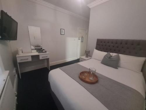 a hotel room with a bed with a tray on it at Hotel 52 in Whitley Bay