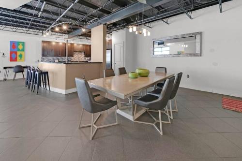 a dining room with a wooden table and chairs at 3 BR 2 BA Downtown Loft water view in Fort Walton Beach