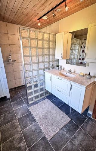a kitchen with a sink and a mirror at Stylish vacation home - close to sea and nature in Hejls