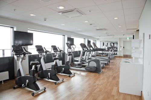 a gym with treadmills and elliptical machines at Scandic Sydhavnen in Copenhagen