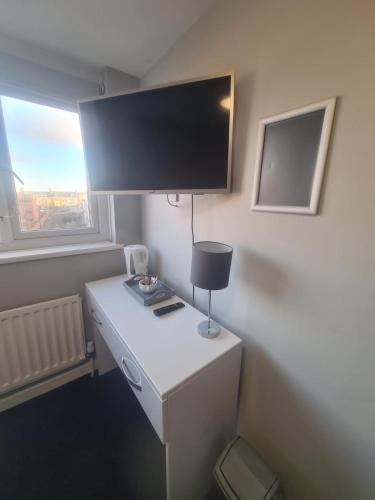 a room with a desk with a tv on it at Hotel 52 in Whitley Bay