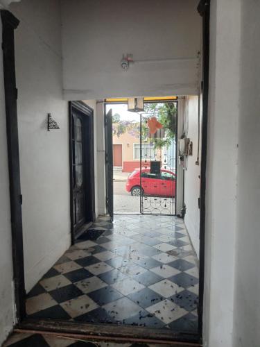 an empty hallway with a mirror and a red car at Alojamiento Irastorza in Nueva Palmira