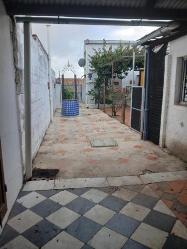 an empty alley with a tile floor in a building at Alojamiento Irastorza in Nueva Palmira
