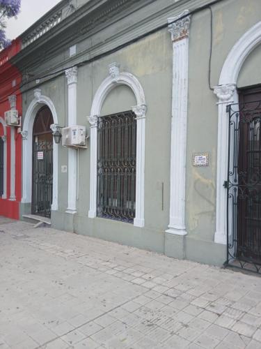 a building with two gates on the side of a street at Alojamiento Irastorza in Nueva Palmira