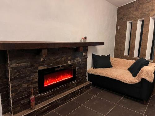 a living room with a brick fireplace with a couch at Casa Stone Laja in Guadalajara