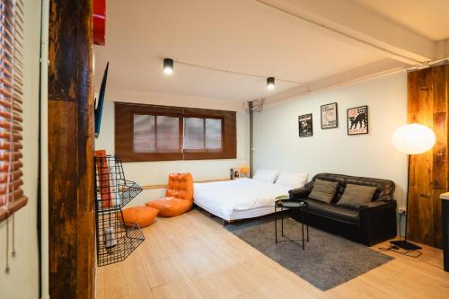 a bedroom with a bed and a couch at Dec room at bangsue in Bang Su