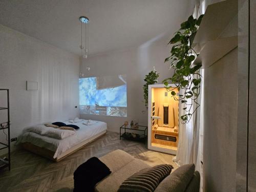 a bedroom with a bed and a mirror and a couch at Solaris Home Spa in Fiuggi