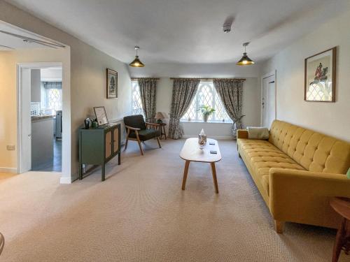 a living room with a couch and a table at The Merchants Penthouse - Uk50408 in Canterbury
