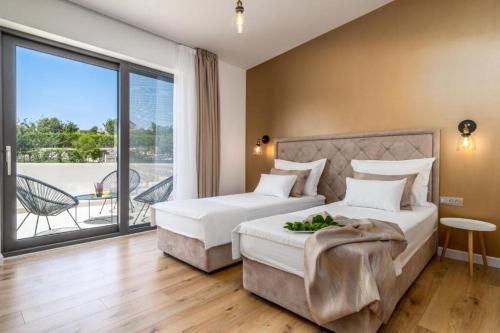 a hotel room with two beds and a balcony at Villa Eden with heated pool in Omiš