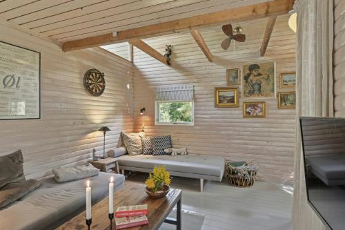 a living room with a couch and a table at Wooden House With Wild Garden By Sejerø Bay in Kalundborg