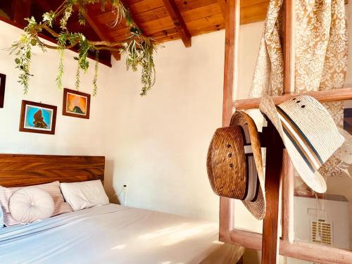 a bedroom with a bed with a wooden frame at Katary Gro in Marquelia