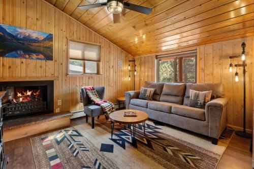 a living room with a couch and a fireplace at Cabin 1- Hot Tub Grill- Mins to RMNP in Estes Park