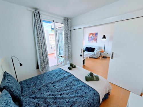 a bedroom with a bed and a large window at Canary Dreams Ocean View in Playa del Cura
