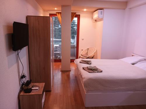 a small room with a bed and a tv and a room with at Apartment Riki 2 in Ohrid