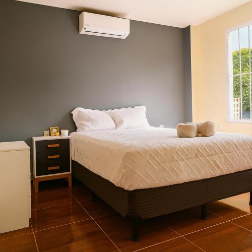 a bedroom with a bed and a window at Mi Tierra Surf City in El Majahual