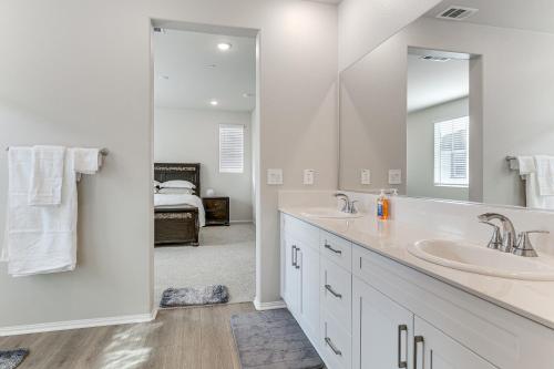 a bathroom with two sinks and a large mirror at Near Hospitals Home with Pool Access in Temecula in Linda Rose