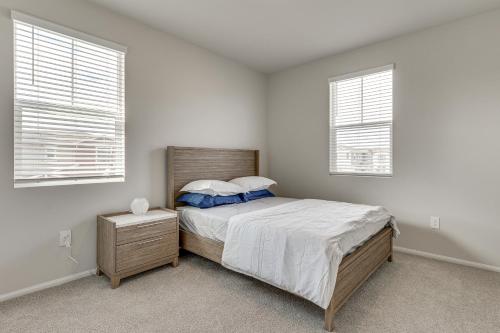 a white bedroom with a bed and two windows at Near Hospitals Home with Pool Access in Temecula in Linda Rose