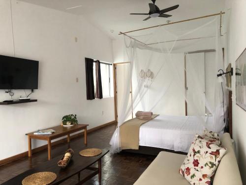 Giường trong phòng chung tại Jardinatta