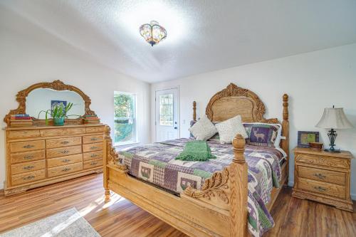 een slaapkamer met een houten bed en een dressoir bij Riverfront Relaxation Secluded Jacksonville Home in Buncom