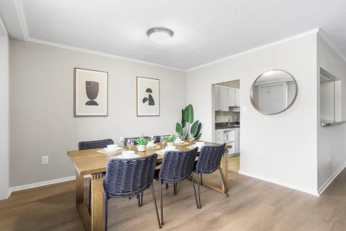a dining room with a table and chairs and a mirror at Modern Apt in Crystal City Near the Airport in Arlington