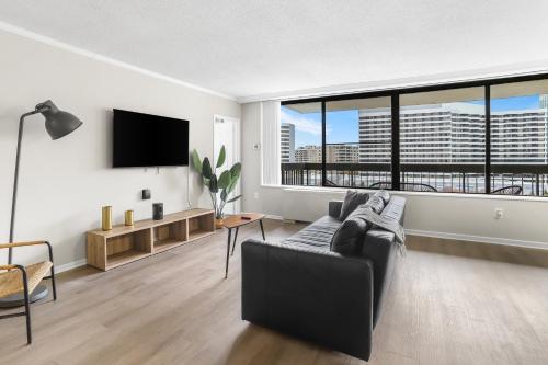 a living room with a couch and a large window at Modern Apt in Crystal City Near the Airport in Arlington