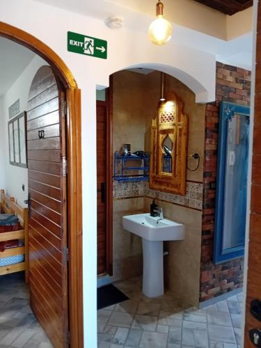 a bathroom with a sink and a mirror at Villa Azzurra in Imsouane