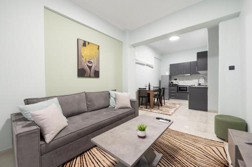a living room with a couch and a table at Serra Modern Apt " Free Parking " Quiet " Near Center in Serres