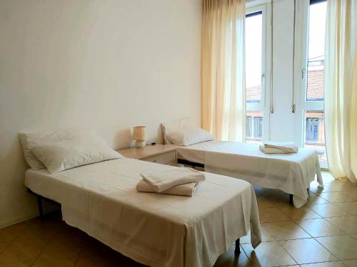 博洛尼亚Alam B&B Bologna的有窗户的房间里有两张床