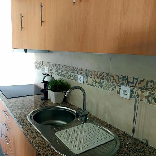 a kitchen sink with a strainer next to it at HOUSE 4U - Modern Mezzanine Apartment with AC, Wi-Fi and Parking - Abrantes in Abrantes