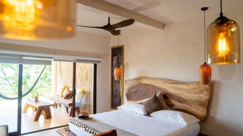 a bedroom with a bed with a wooden headboard at Casa Gaya in San Pedro Pochutla