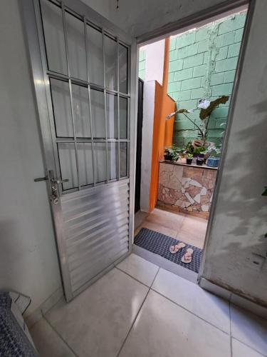 une porte ouverte sur une pièce avec une plante dans l'établissement Condominio Merces, à Belo Horizonte