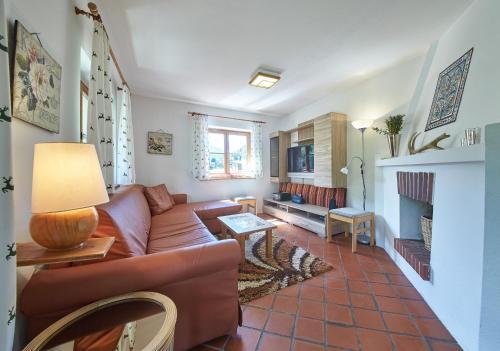 a living room with a couch and a fireplace at Holiday Lodge Felix in Saalbach-Hinterglemm