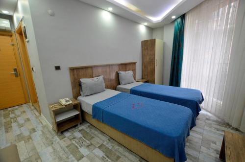 Postel nebo postele na pokoji v ubytování Tüm Palace Otel