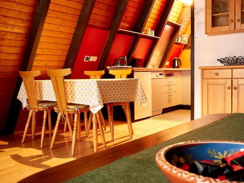 a kitchen with a table and chairs in a room at Ferienhaus In Waldkirchen Mit Garten Und Seeblick in Waldkirchen