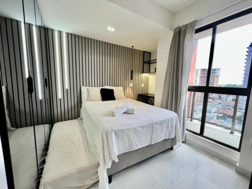 Ένα ή περισσότερα κρεβάτια σε δωμάτιο στο Compact Time - Miramar Hospedagens