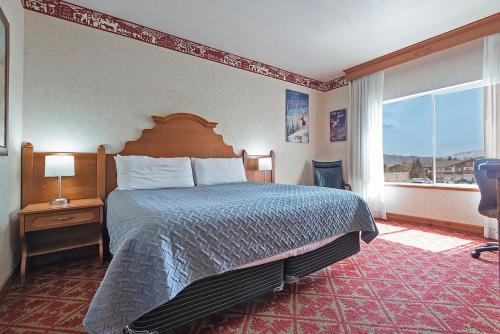 a hotel room with a bed and a large window at Spacious King Suite in the Heart of Midway Near Park City & Sundance Ski Resorts - 209 in Mound City