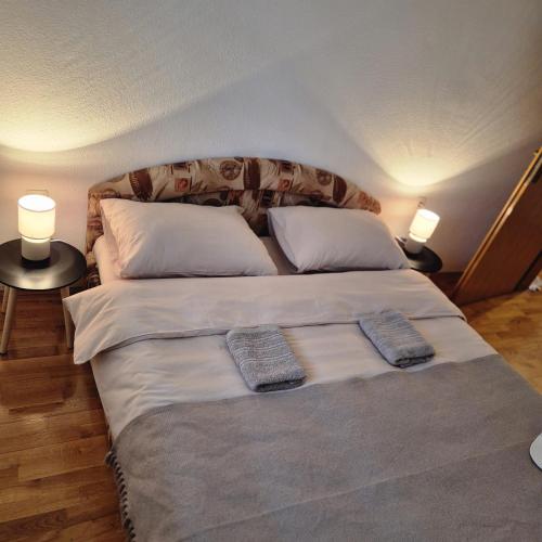 a large bed in a room with two pillows on it at Livno Sympan in Livno